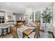 Sunlit dining area with table, chairs, and a view into the bright and open living room at 317 Chanticlair Dr, Apex, NC 27502