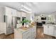 Modern kitchen with stainless steel appliances, white cabinets, granite countertops and an open layout at 317 Chanticlair Dr, Apex, NC 27502