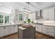 Modern kitchen featuring a center island, stainless steel appliances and granite countertops at 317 Chanticlair Dr, Apex, NC 27502