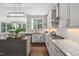 White cabinets and granite countertops grace this spacious kitchen with modern fixtures at 317 Chanticlair Dr, Apex, NC 27502