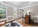 Bright living room with hardwood floors, bar, and large windows, perfect for entertaining at 317 Chanticlair Dr, Apex, NC 27502