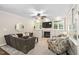 Inviting living room featuring a cozy fireplace, built-in cabinets, a ceiling fan and comfortable seating at 317 Chanticlair Dr, Apex, NC 27502