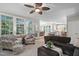 Cozy living room with large windows providing natural light and views into the kitchen at 317 Chanticlair Dr, Apex, NC 27502