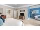 The main bedroom features blue accents, neutral walls, plush carpet, a walk-in door to the ensuite and a sitting area at 317 Chanticlair Dr, Apex, NC 27502