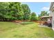 Enjoy a private backyard with a covered patio, mature trees, and landscaping for outdoor enjoyment and relaxation at 326 Hope Valley Rd, Knightdale, NC 27545