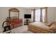 Calm bedroom featuring a dresser with mirror and a TV mounted on a stand at 326 Hope Valley Rd, Knightdale, NC 27545