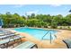 This community pool boasts clear blue water, sun loungers, and lush landscaping for a refreshing retreat at 326 Hope Valley Rd, Knightdale, NC 27545
