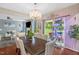 Dining room featuring a large table, chandelier, and view of the outdoor patio at 326 Hope Valley Rd, Knightdale, NC 27545
