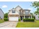 Charming two-story home featuring stone accents, a covered porch, and a well-manicured lawn at 326 Hope Valley Rd, Knightdale, NC 27545