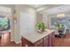 Well-lit kitchen island with granite countertops and views of the open concept dining room at 326 Hope Valley Rd, Knightdale, NC 27545