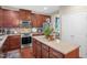 Cozy kitchen featuring stainless steel appliances, granite countertops, and a center island with storage at 326 Hope Valley Rd, Knightdale, NC 27545