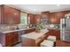 Beautiful kitchen featuring stainless steel appliances, stone countertops, and a center island with seating at 326 Hope Valley Rd, Knightdale, NC 27545