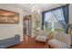 Cozy living room featuring a chandelier, hardwood floors, and comfortable seating at 326 Hope Valley Rd, Knightdale, NC 27545