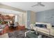 Relaxing living room showcases an open floor plan with a white couch, ceiling fan, and interior plants at 326 Hope Valley Rd, Knightdale, NC 27545