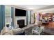 Cozy living room featuring a fireplace, TV, grey rug, and an open floor plan at 326 Hope Valley Rd, Knightdale, NC 27545