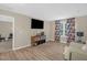 Cozy living room with wood floors, a large window with curtains, and a media center at 326 Hope Valley Rd, Knightdale, NC 27545