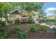 Stunning backyard view showcasing the home's deck and lush landscaping at 3324 Thomas Rd, Raleigh, NC 27607