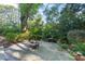 Beautiful backyard oasis with stone patio, fire pit, waterfall feature, and lush greenery, perfect for outdoor relaxation at 3324 Thomas Rd, Raleigh, NC 27607