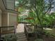 An inviting backyard featuring a deck, an outdoor dining area with umbrella, and a stone patio with a cozy fire pit at 3324 Thomas Rd, Raleigh, NC 27607