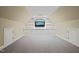 Finished basement with built-in shelving and media center with grey carpet at 3324 Thomas Rd, Raleigh, NC 27607