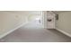 Finished basement with built-in shelving, neutral walls and grey carpet at 3324 Thomas Rd, Raleigh, NC 27607