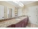 Bathroom featuring granite countertops, double sinks, and neutral tile flooring at 3324 Thomas Rd, Raleigh, NC 27607