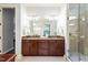 This primary bath boasts double sinks, granite countertops, and a separate glass enclosed shower at 3324 Thomas Rd, Raleigh, NC 27607
