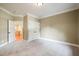Cozy bedroom featuring neutral carpet, crisp white trim and a view to a relaxing sitting room at 3324 Thomas Rd, Raleigh, NC 27607