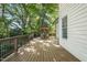 A beautiful deck features an outdoor dining set with a red umbrella, creating a perfect spot for entertaining guests at 3324 Thomas Rd, Raleigh, NC 27607