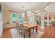 Bright dining room featuring hardwood floors, stylish lighting, and views of the outdoors at 3324 Thomas Rd, Raleigh, NC 27607