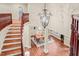 Staircase leading to a dining room with a chandelier, hardwood floors, and large windows at 3324 Thomas Rd, Raleigh, NC 27607