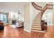 A grand entryway with a curved staircase opens to the living room with a fireplace and built-in shelves at 3324 Thomas Rd, Raleigh, NC 27607