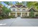 Charming two-story home featuring elegant columns, rocking chairs, and a welcoming entryway at 3324 Thomas Rd, Raleigh, NC 27607