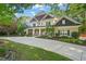 Beautiful two-story home with mature trees, manicured landscaping and a concrete driveway at 3324 Thomas Rd, Raleigh, NC 27607