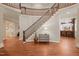 Elegant foyer with hardwood floors, a curved staircase, and stylish decor at 3324 Thomas Rd, Raleigh, NC 27607