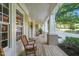 Inviting front porch with rocking chairs and classic columns, perfect for relaxing outdoors at 3324 Thomas Rd, Raleigh, NC 27607