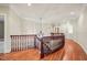 Elegant hallway with hardwood floors and a decorative wrought iron chandelier at 3324 Thomas Rd, Raleigh, NC 27607