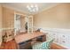 This home office features built-in cabinets, hardwood floors, and stylish light fixtures with an open view at 3324 Thomas Rd, Raleigh, NC 27607