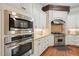Gourmet kitchen with stainless steel appliances, tile backsplash and granite countertops at 3324 Thomas Rd, Raleigh, NC 27607