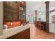 Kitchen features granite countertops, dark wood cabinetry, and breakfast bar with seating at 3324 Thomas Rd, Raleigh, NC 27607