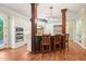 Kitchen features white cabinets, stainless steel appliances and dark wood pillars around breakfast bar at 3324 Thomas Rd, Raleigh, NC 27607