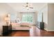The bright and airy main bedroom features a large window, hardwood floors, and a comfortable aesthetic at 3324 Thomas Rd, Raleigh, NC 27607