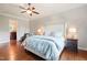 The main bedroom boasts a beautiful ceiling fan, hardwood floors, and soft, natural light at 3324 Thomas Rd, Raleigh, NC 27607