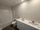 Bathroom featuring double vanity, neutral walls, modern fixtures, and tub with shower at 37 Chloe Ct, Selma, NC 27576