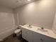 Bright bathroom with double vanity, quartz countertop, modern fixtures, and tile surround tub at 37 Chloe Ct, Selma, NC 27576