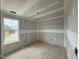 Bright unfinished bedroom featuring a window and closet, ready for customization and design at 37 Chloe Ct, Selma, NC 27576