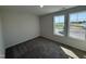 Bright bedroom featuring plush carpeting and large windows offering abundant natural light and neighborhood views at 37 Chloe Ct, Selma, NC 27576