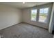 Bedroom with neutral walls, plush carpeting, and natural light from two windows at 37 Chloe Ct, Selma, NC 27576