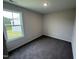 Bedroom featuring neutral walls, plush carpeting, and a large window offering a scenic view at 37 Chloe Ct, Selma, NC 27576