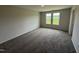 Bedroom with neutral walls, plush carpeting, and a bright, picturesque window view at 37 Chloe Ct, Selma, NC 27576